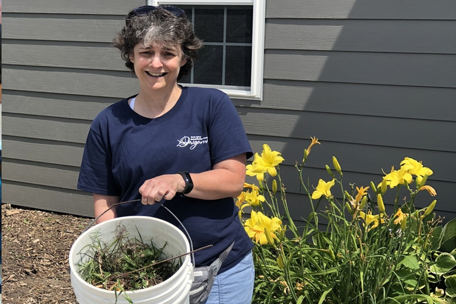 A volunteer helps out with planting flowers on the grounds.