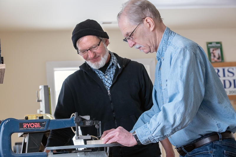 Employee working with a residential client in the woodshop.