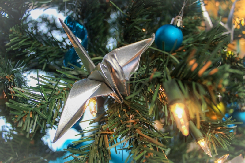 Silver crane and lights on a christmas tree