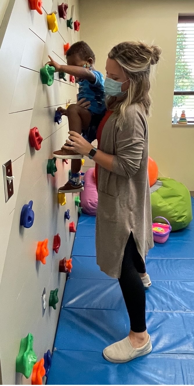 An Origami Occupational Therapist work with a young client in the pediatrics room