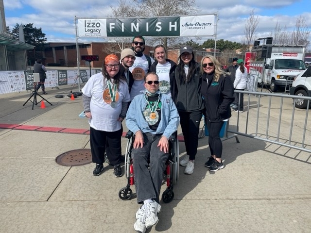 Origami residents and team members gathered for a photo at the 2022 Izzo Legacy Run/Walk/Roll event