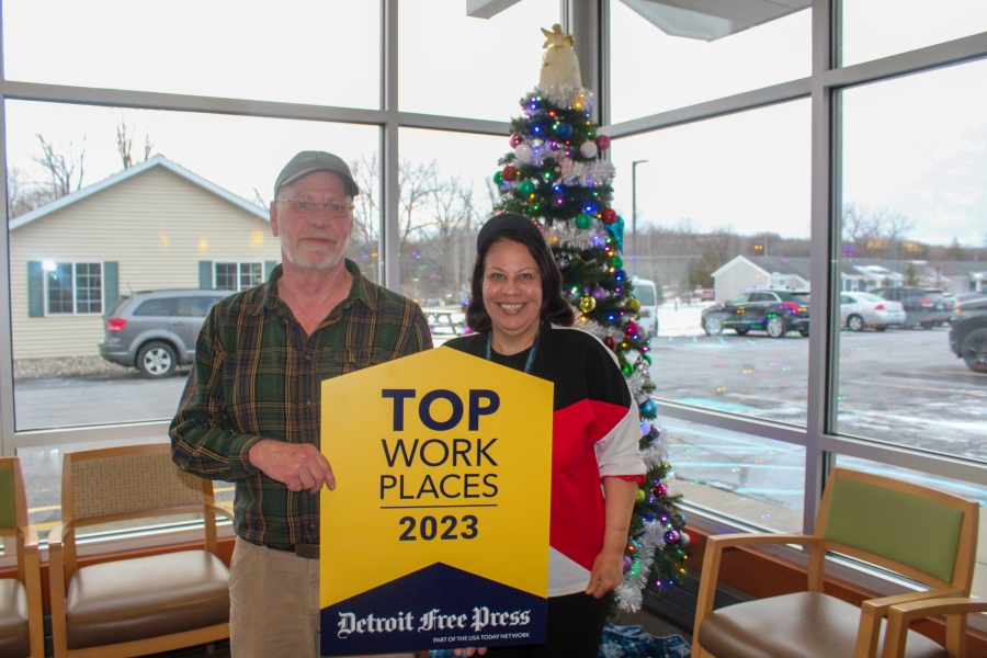 Origami Team members hold the top workplaces sign and smile (3)