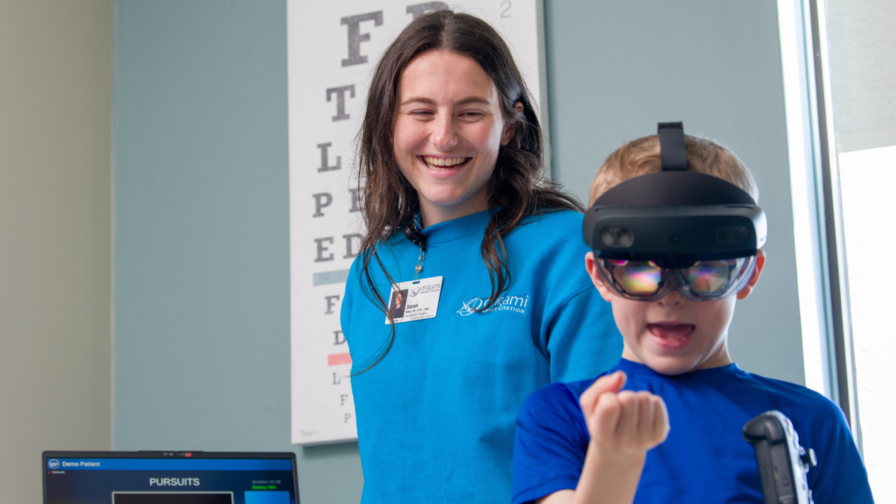 Origami occupational therapist works with young client on concussion rehabilitation