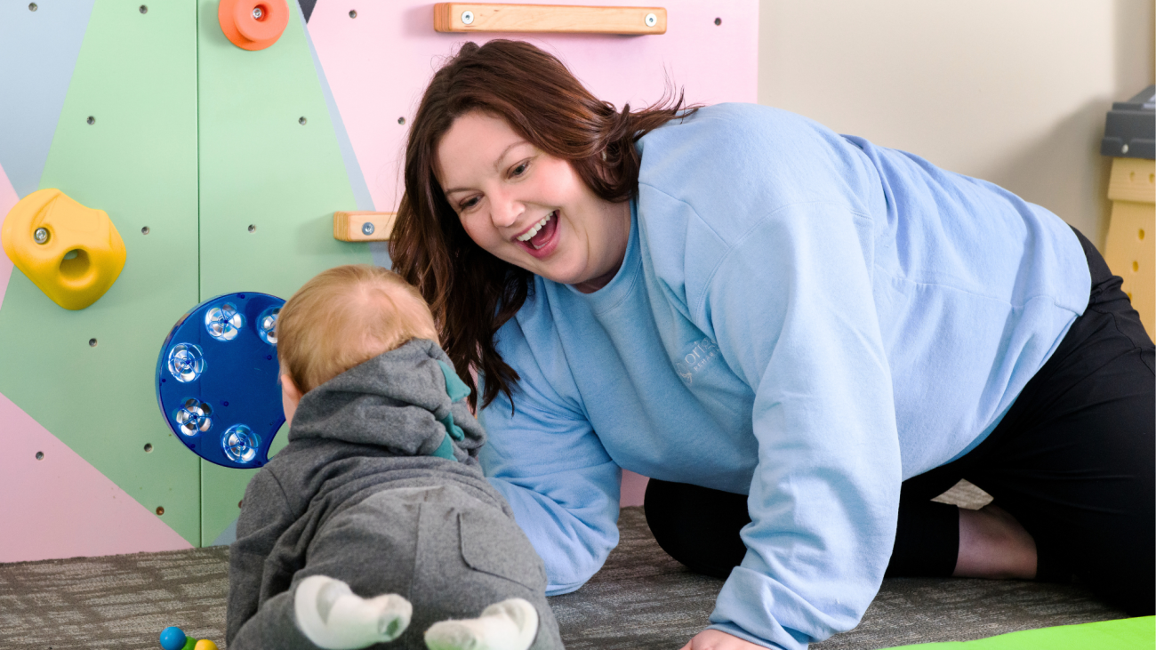 Origami clinician works with an infant on physical therapy